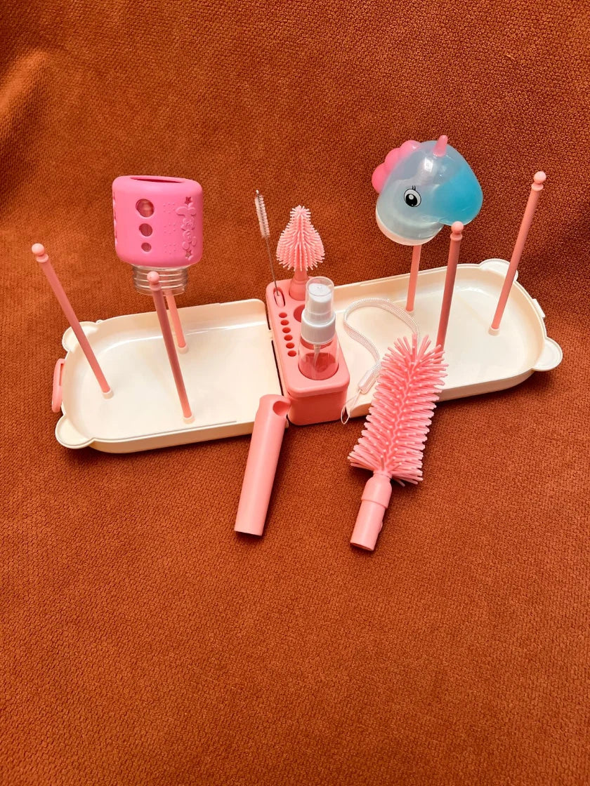 Pink dental care product set with brushes and a holder on a brown background