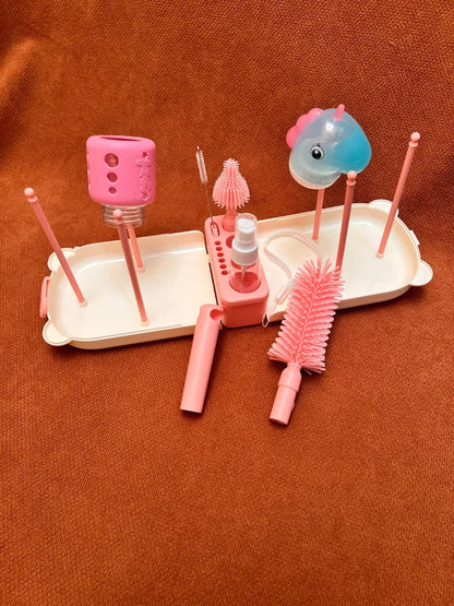 Pink dental care product set with brushes and a holder on a brown background